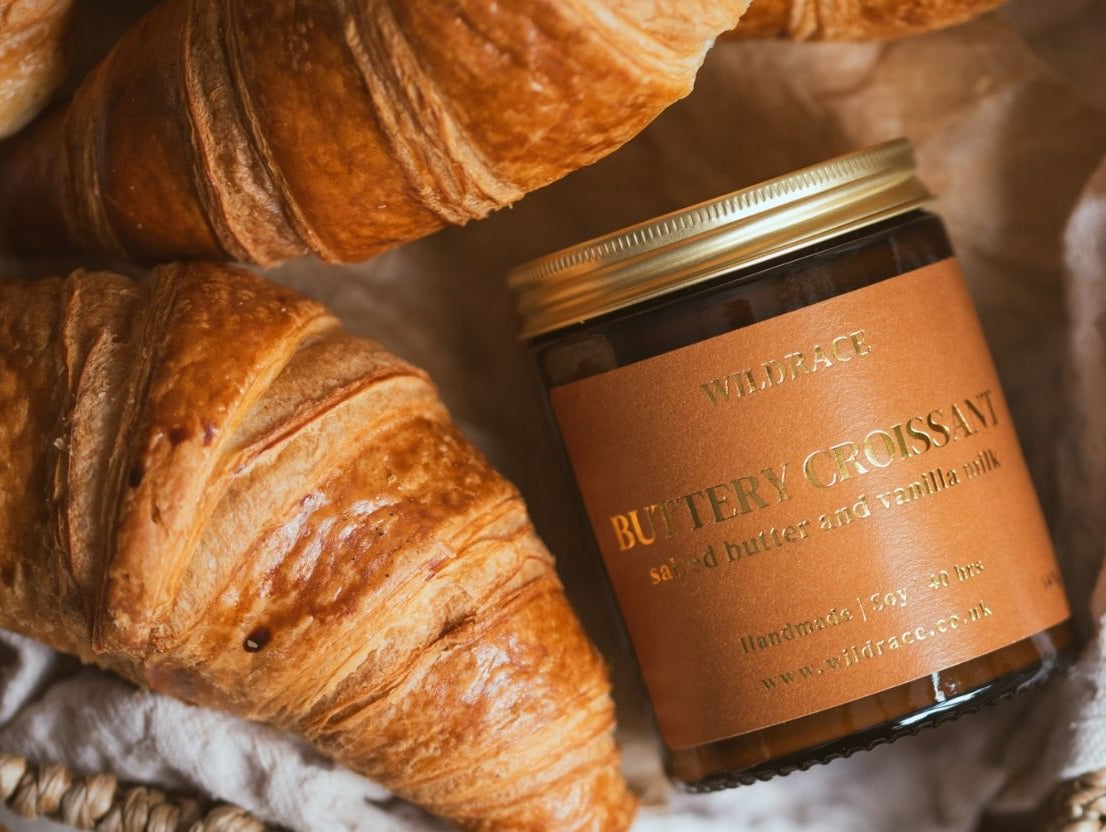 croissant candle in a basket with croissants