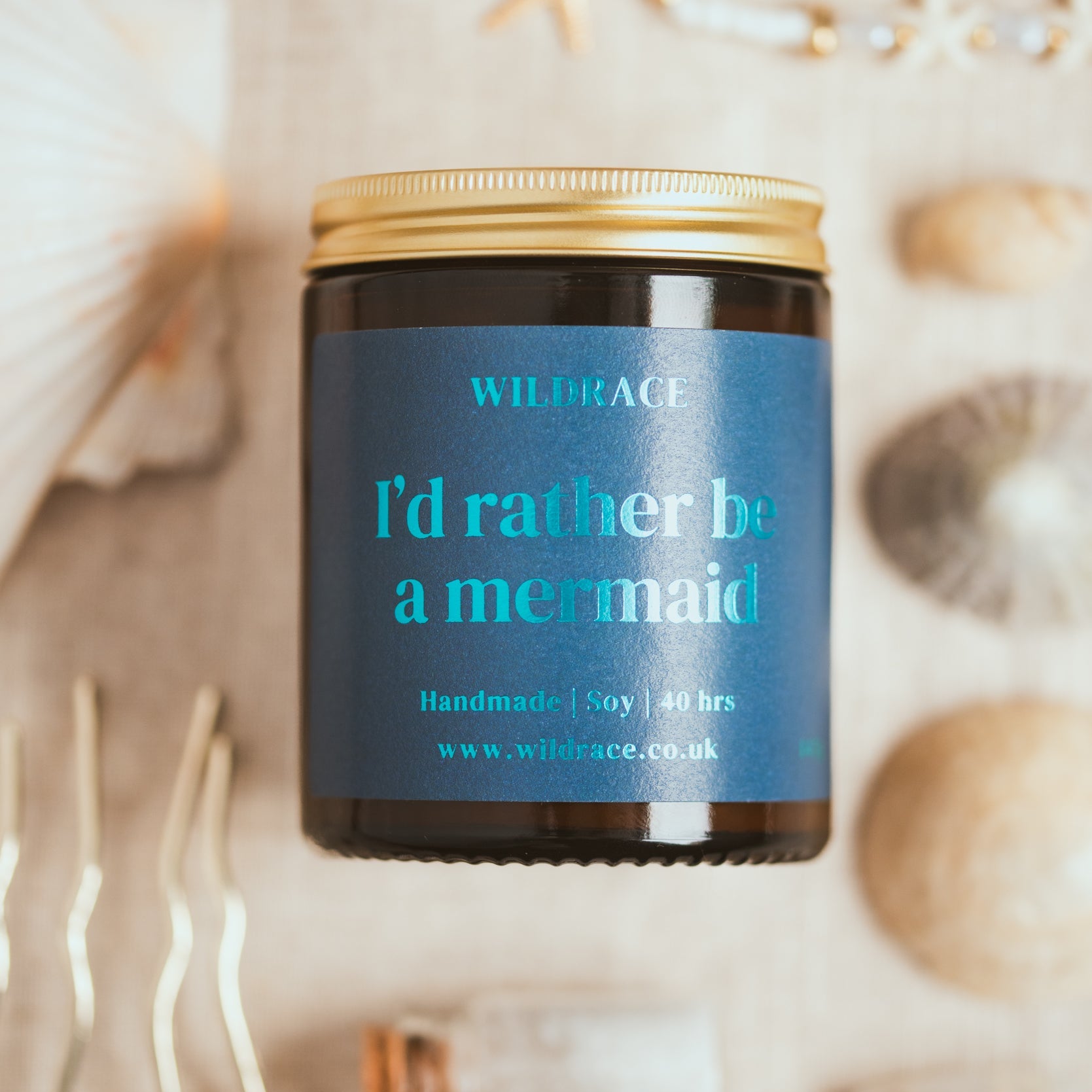 Candle jar with 'I'd rather be a mermaid' label on seashell background