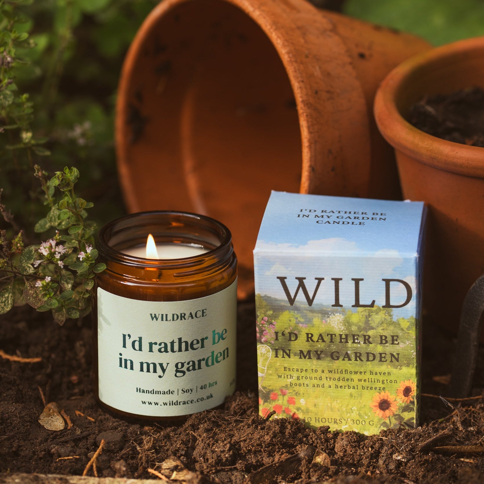 Candle and packaging with 'Wild' branding in a garden setting