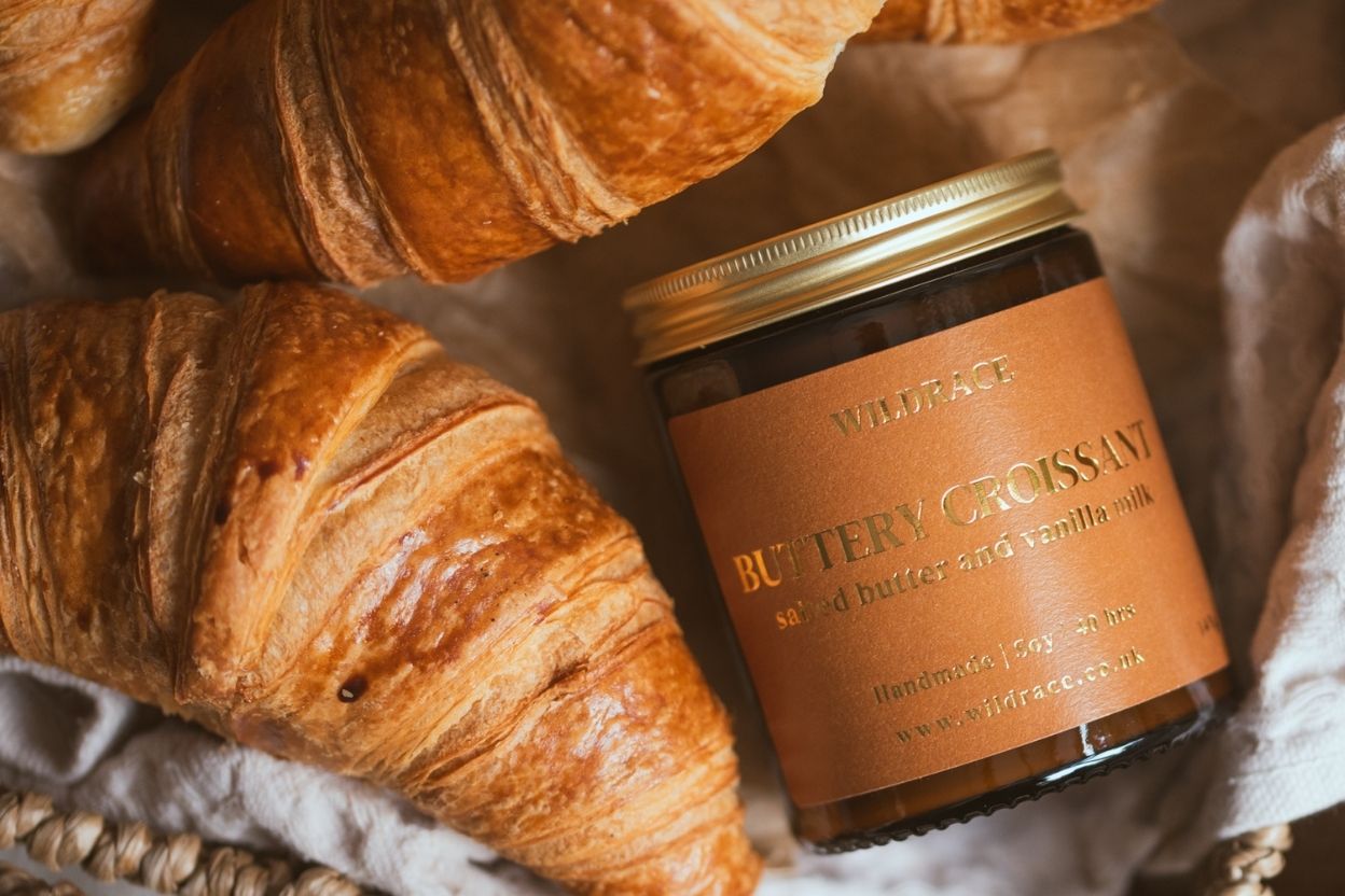 croissant candle in a basket with croissants